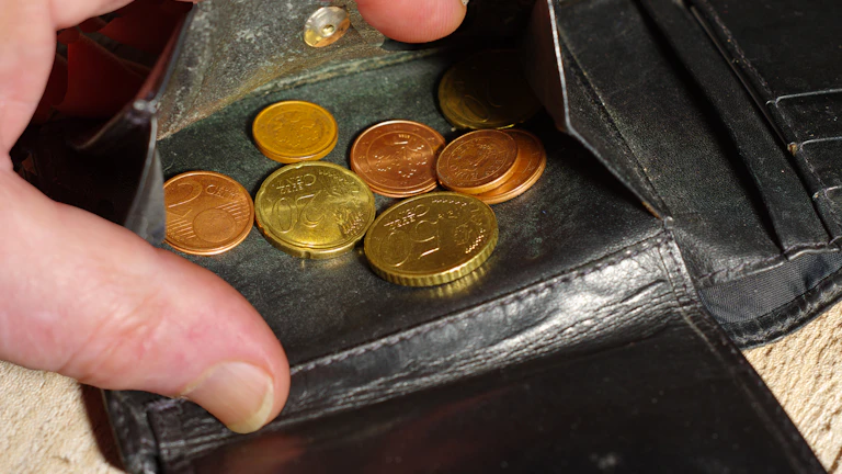 돈을 조심스럽게 세고 있는 사람