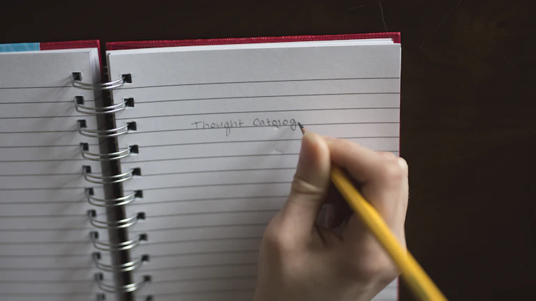 노트북에 글을 쓰고 있는 사람